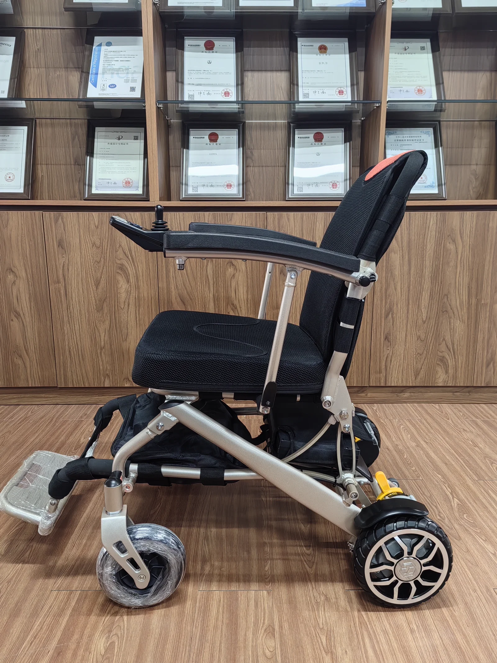EW100 lightweight aluminum electric wheelchair, side view in factory showroom